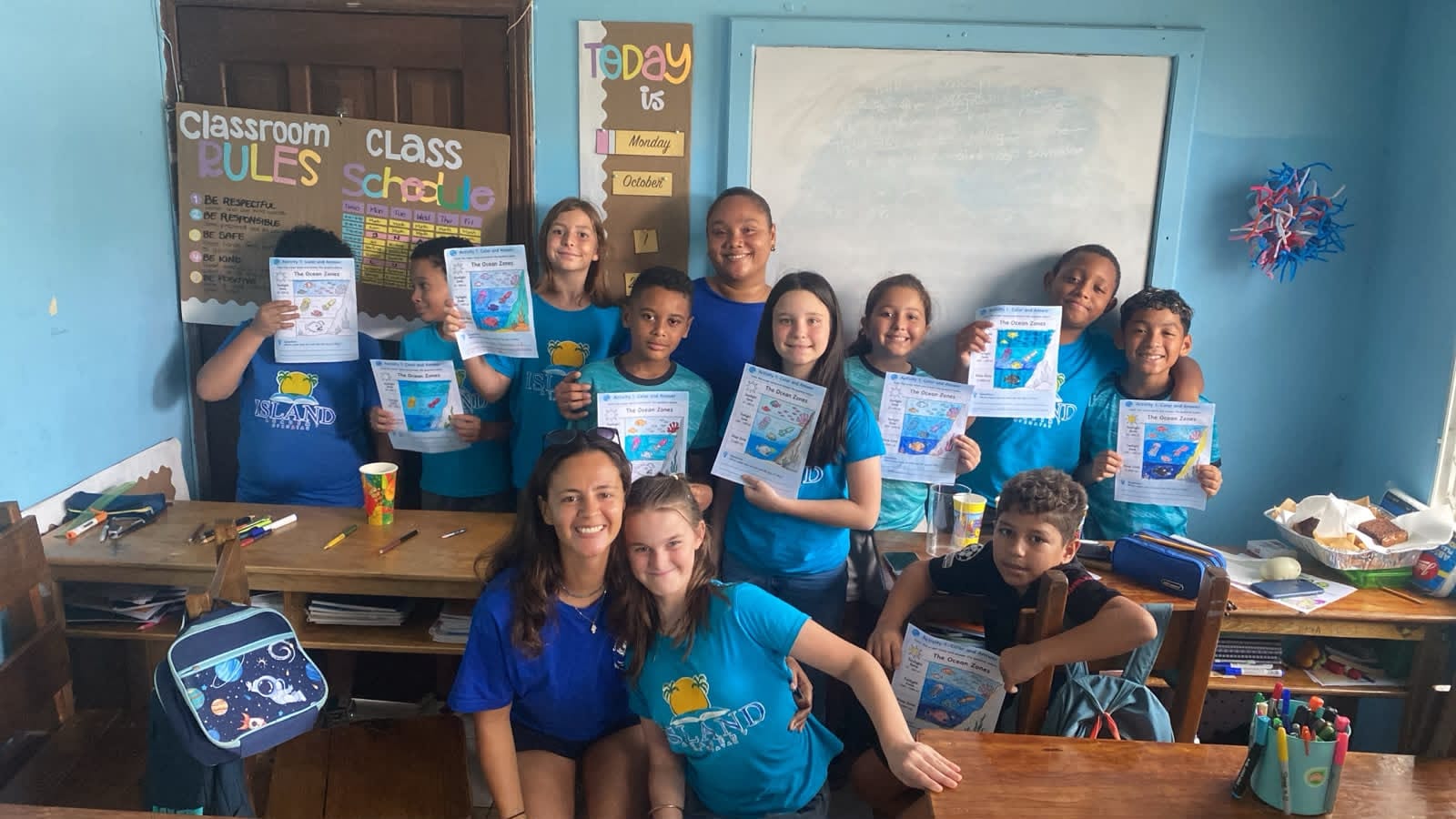 Caribbean Reef Guardians educational group participating in a coral reef conservation activity with local students in Roatan.