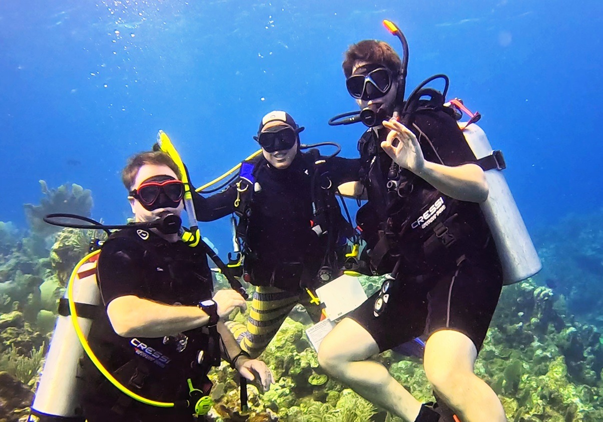 Scuba divers exploring a coral reef in Roatan during a supervised introductory dive